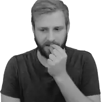 a man with a beard is biting his fingers