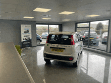 a courtney car is parked in a showroom