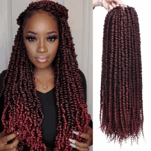 a woman with long red dreadlocks is holding a bundle of hair