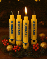 four yellow candles with the word jokari on them are lit