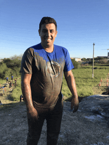 a man wearing a blue shirt that says texas on it