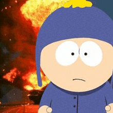 a cartoon character from south park is standing in front of a burning building .