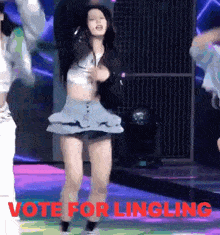 a woman in a short skirt is dancing on a stage with the words vote for lingling written in red .