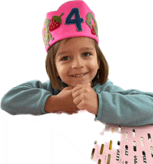 a little girl wearing a pink hat with the number four on it