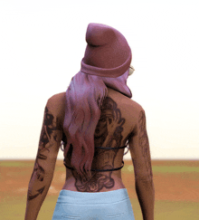 a woman with purple hair has a tattoo on her back with the number 10