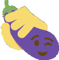 a hand is holding an eggplant with a face on it .