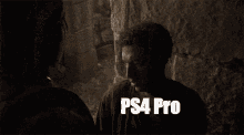 a man is talking to another man in a dark room with the words ps4 pro written on the screen .