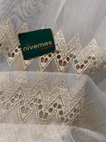 a piece of fabric with a label that says nivemes home on it