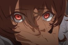 a person with red eyes is covering their face with their hand