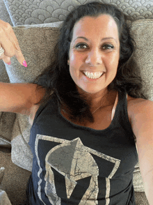 a woman in a black tank top with a spartan helmet on it