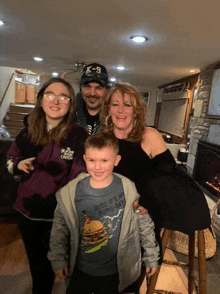 a family posing for a picture with one child wearing a shirt that says dude it 's my big-day