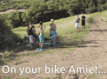 a group of people standing on a dirt road with the words " on your bike amie " on the bottom