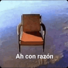 a chair is flying through the air with the words ah con razon written on it .