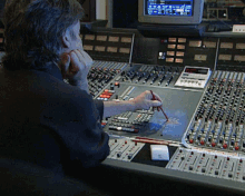 a man sitting at a desk with a calculator and a pencil in front of a screen that says ' abc '