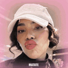a woman wearing a white hat with matate written on the bottom