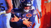 a football player wearing a jersey with a letter m on it