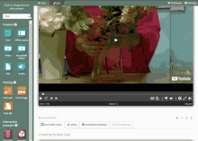 a screenshot of a youtube video showing a person holding a vase of flowers