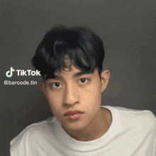 a young man 's face is shown with a tiktok watermark