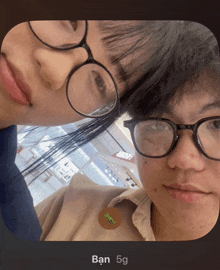 two people wearing glasses and a button that says ban 5g on it