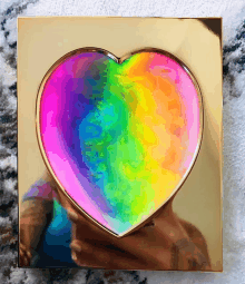 a heart shaped container with a rainbow inside