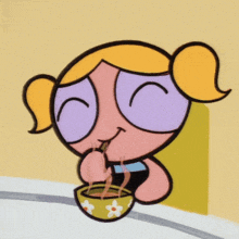 bubbles from the powerpuff girls drinks through a straw from a bowl