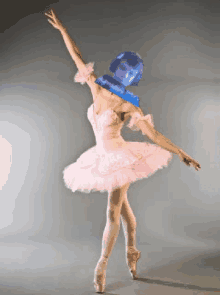 a ballerina in a pink tutu is dancing with a blue background