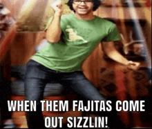 a man in a green shirt is dancing with a caption that says when them fajitas come out sizzlin !