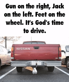 a red nissan truck is parked in a parking lot with a ball attached to the back .