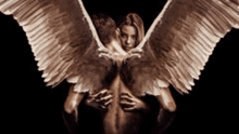 a man and a woman with angel wings are hugging each other on a black background .