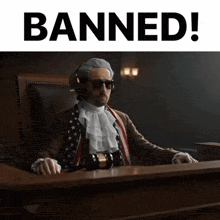 a man in a judge 's chair with the words banned behind him