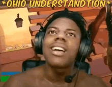 a shirtless man wearing headphones and a microphone is looking up at the sky .