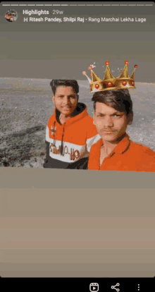 two young men are posing for a picture with a crown on their heads