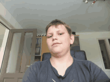 a young boy taking a selfie in a room