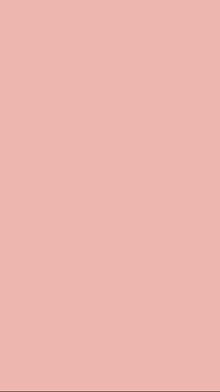 a close up of a light pink background with a plain texture .