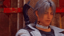 a man with a tattoo on his neck is wearing a choker