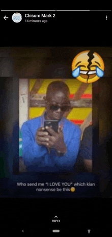 a picture of a man holding a cell phone with a smiley face behind him .