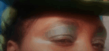 a close up of a woman 's face with a hat on