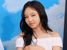 a woman in a white off the shoulder top has the word love on her face