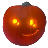 a carved pumpkin with glowing eyes and a smile