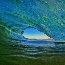 a wave is breaking on the shore and looking out of the tube