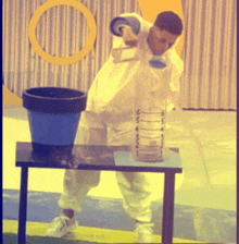 a man stands on a table with a measuring cup that says ' a ' on it