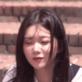 a close up of a girl with her eyes closed