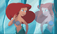 ariel from the little mermaid looking at her reflection in a mirror