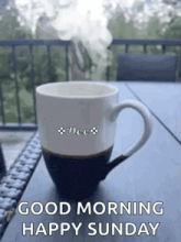 a cup of coffee with steam coming out of it on a table .