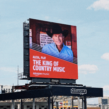 a billboard for alexa play the king of country music shows a man in a cowboy hat