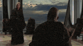 a man in a robe stands in front of a group of men