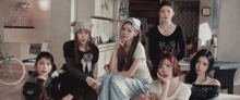 a group of young women are posing for a picture in a room
