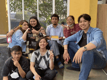 a group of people posing for a picture with one man wearing a navy shirt