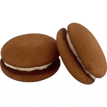 two chocolate sandwich cookies with white frosting on them