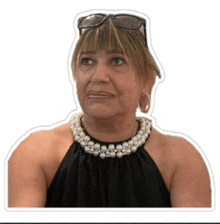 a woman wearing sunglasses and a pearl necklace is making a face